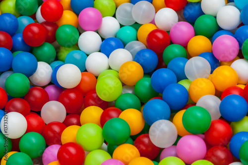 Colored plastic toy balls of different color for the children's pool dry. Top view close up. Picture background, wallpaper, texture, pattern.