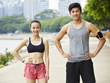 outdoor portrait of asian exercising man and woman