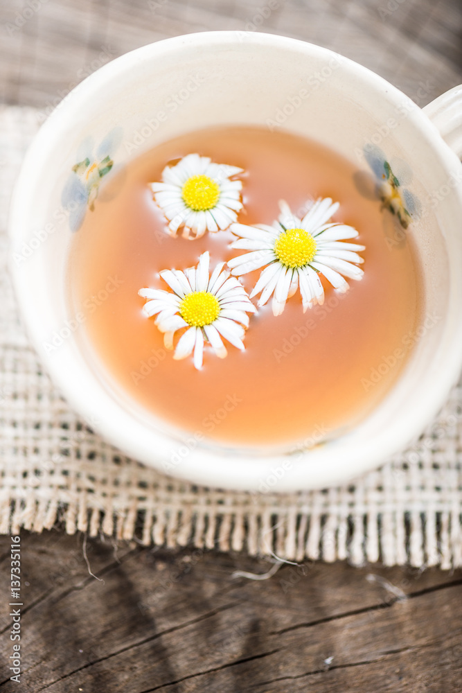 chamomile tea in a glass cup on wooden background chamomile tea in a glass cup on wooden background