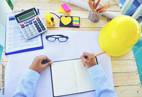 Wallpaper Mural A young Asian  Architect drawing on architectural project business, architecture, building, construction and people concept - close up of architect hands with blueprint ,Yellow helmet Torontodigital.ca