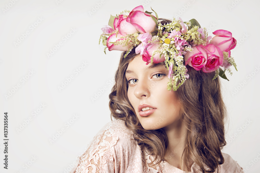 Portrait of a girl in a wreath of roses on a white background Portrait of a girl in a wreath of roses on a white background