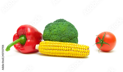 broccoli, tomatoes, corn and sweet pepper on a white background