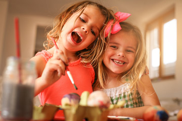 Kids Easter preparation by painting Easter eggs.