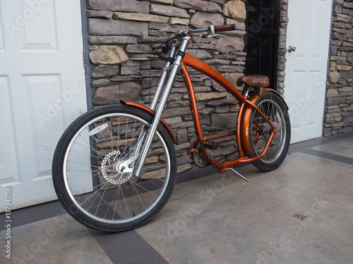 Red Bicycle standing against the wall