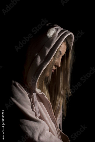 Topless blond woman wearing a cardigan with hood 