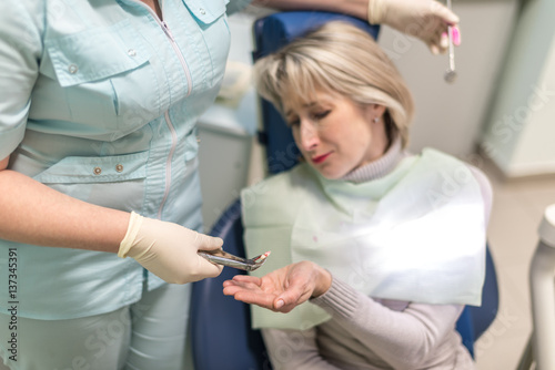 Wallpaper Mural dentist removes the tooth patient at the dental clinic Torontodigital.ca