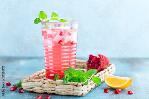 Tableau sur toile Infused pomegranate water with fresh lemon and ice, cold healthy refreshing and