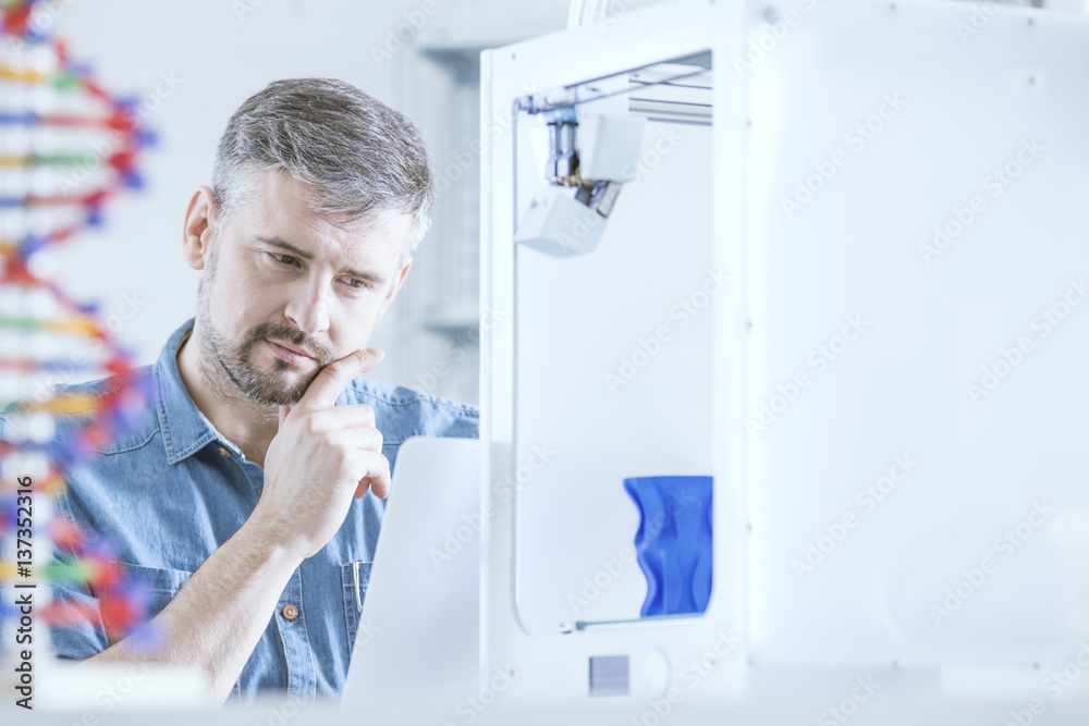 Pensive man and 3d printer