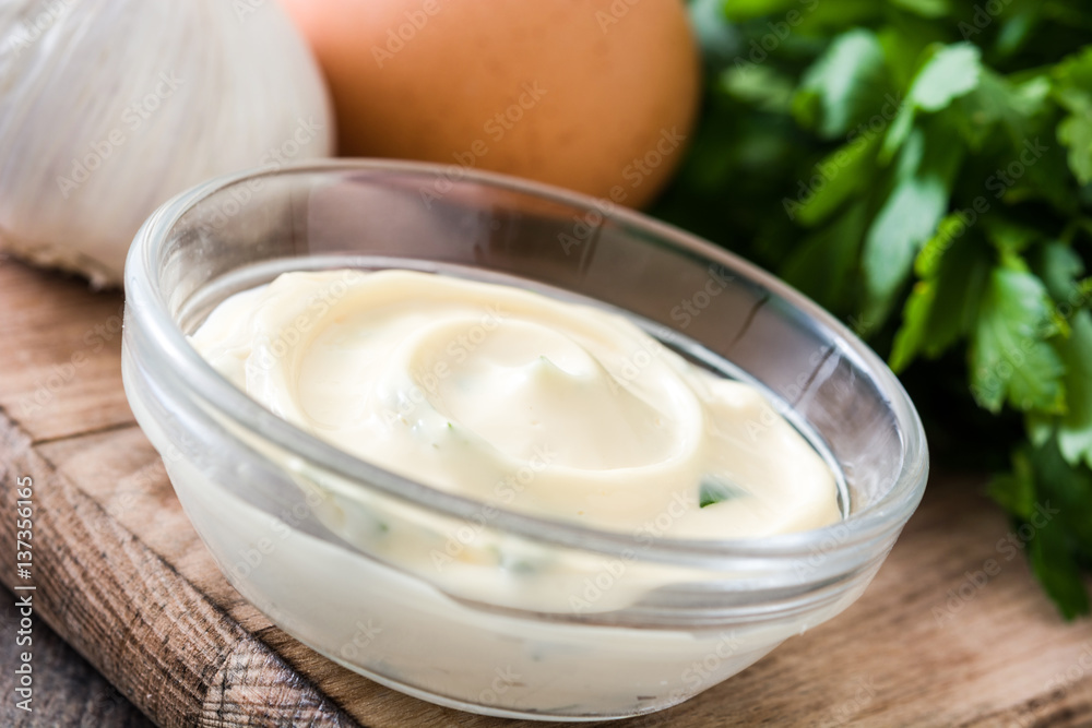 Aioli sauce and ingredients on wooden background
Aioli sauce and ingredients on wooden background
