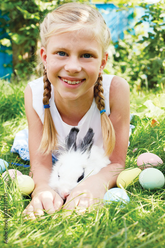 Child hunted on Easter egg  in blooming spring garden.