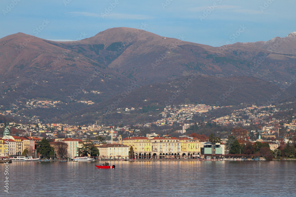 City on coast of lake at foot of mountains. Lugano, Switzerland
