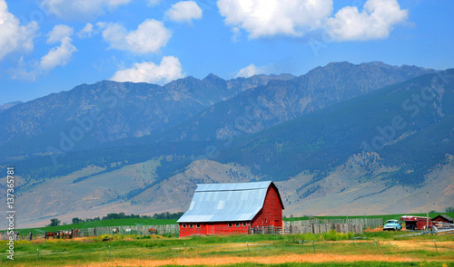 Canvas Print Barn Backed by Mountains