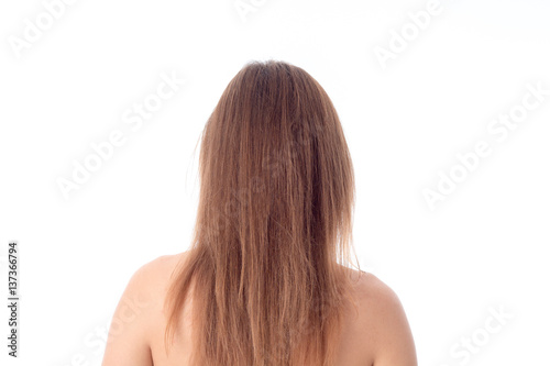 girl with long hair stands his back to the camera isolated on white background