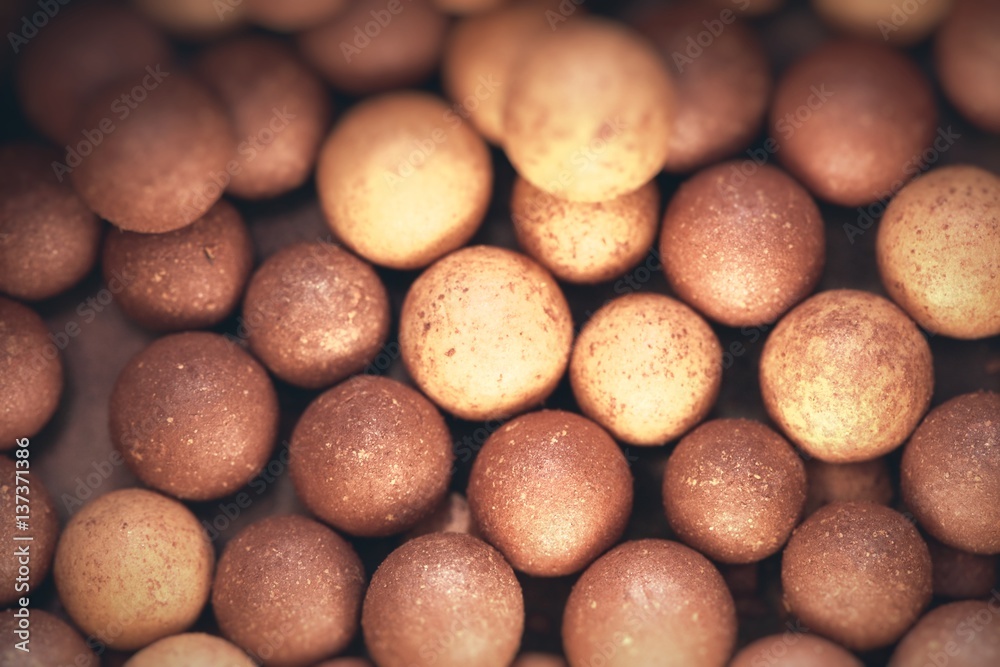 Beige cosmetics multicolor rouge balls background, macro view Beige cosmetics multicolor rouge balls background, macro view