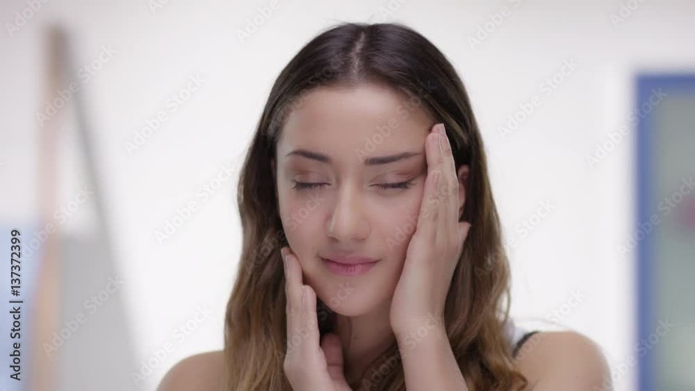 Young woman is pleased with her face skin Young woman is pleased with her face skin