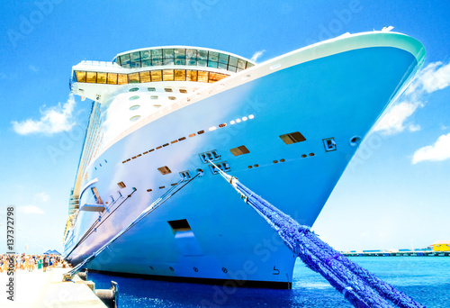 Cruise vacation concept. Cruise ship docked in tropical port. Passenger go to the ship in the cruise port