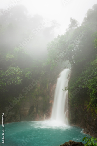 Rio celeste waterfall at foggy day