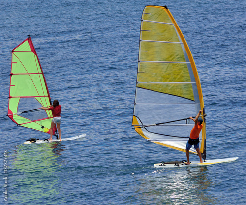 Two windsurfer the ocean - the coach and pupil