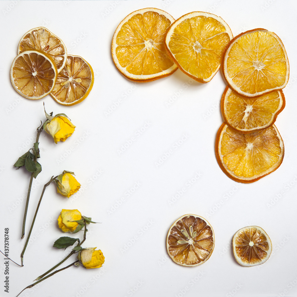 the dried orange and lemon slice with yellow rose on a white background as an art work that can be used for decoration the dried orange and lemon slice with yellow rose on a white background as an art work that can be used for decoration