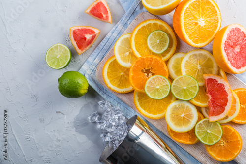 Sliced citrus fruits on sstone background photo