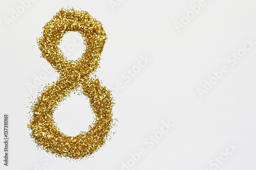 Number 8 March of golden glitter on white background.