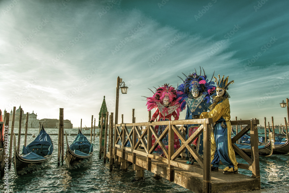 Fototapeta premium people in masks and costumes on Venetian carnival