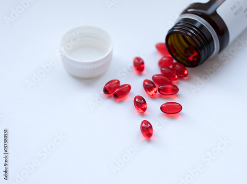 Tabs Vitamins, omega 3, Medications tablets and capsules in a beaker. Medications tablets, suppository bottles, capsules and thermometer on wooden table