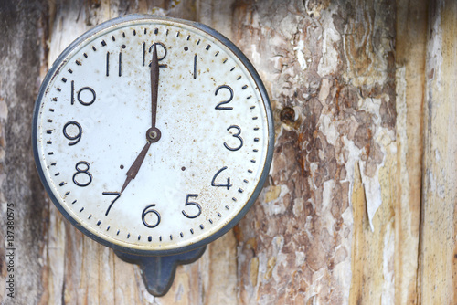 Vintage clock on the background of wooden boards