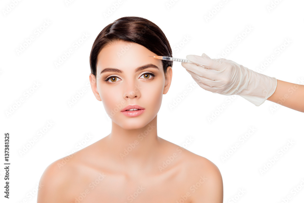 Plastic surgery concept. Botox injection in woman's eyebrow