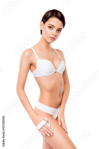Young pretty woman in white underwear doing peeling