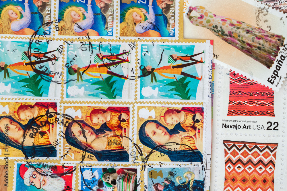 Old used postage printed stamps from various countries as background. For pattern, wallpaper, banner design
