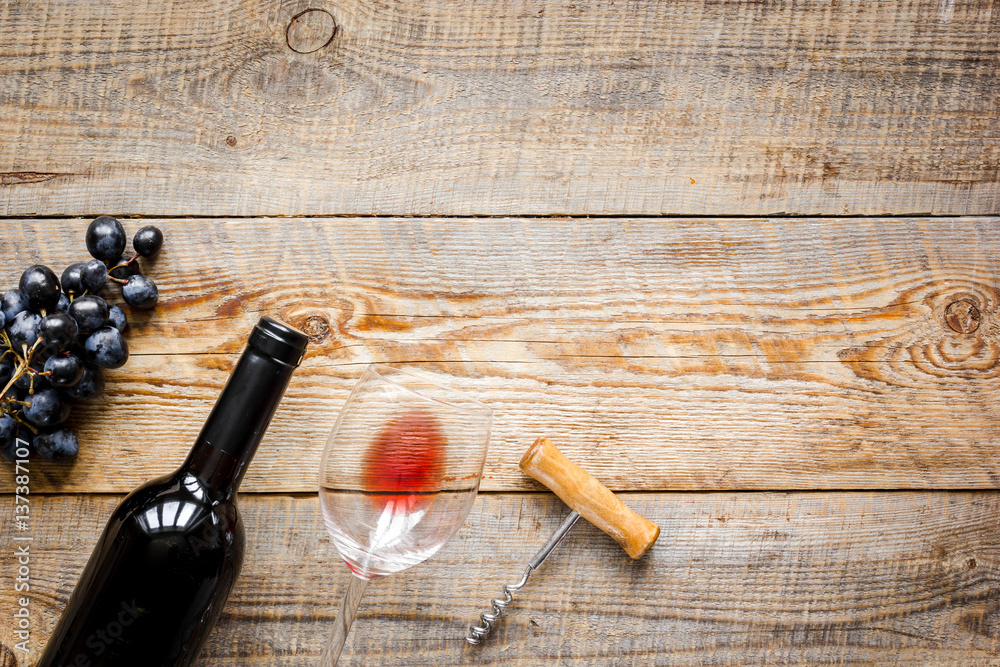 Wine set with bottle and grape on desk top view mockup