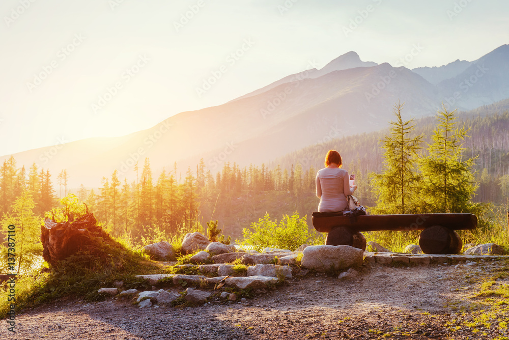 woman on a bench at sunset