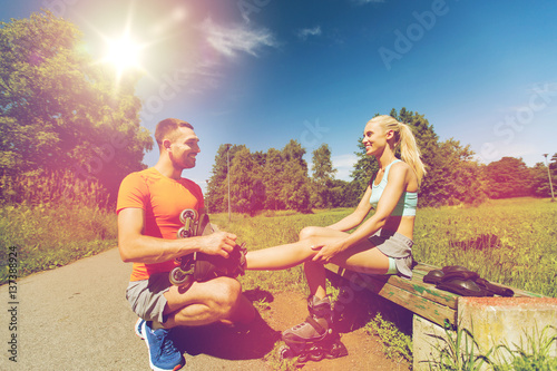 happy couple with rollerblades outdoors