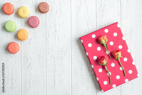 flowers and macaroon on wooden background top view pattern