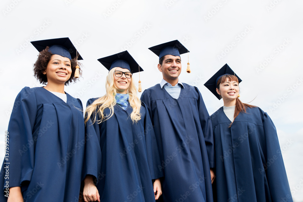 happy students or bachelors in mortarboards happy students or bachelors in mortarboards