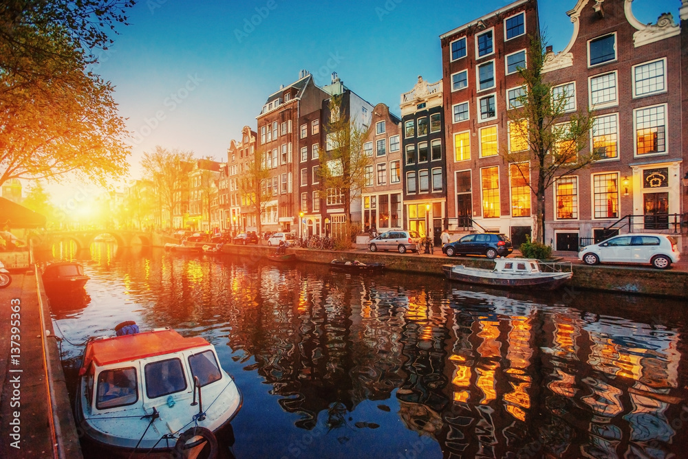 Amsterdam canal. Fantastic sunset is reflected in the water