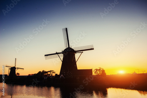 Dutch mill at sunset from the canal in Rotterdam. Holland