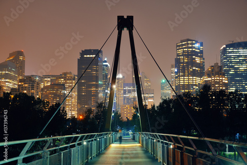 Pedestrian bridge and downtown skyscrapers at hight in Calgary, Canada.