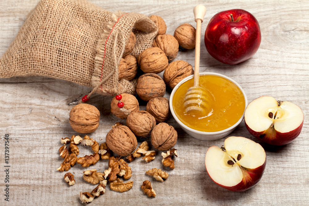 Whole walnuts, kernels and honey on the table Whole walnuts, kernels and honey on the table
