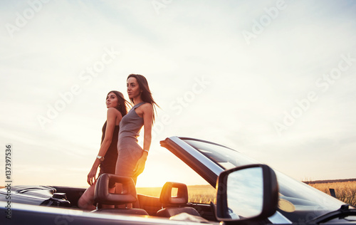 Young two women at a photo shoot. Girls gladly posing © standret