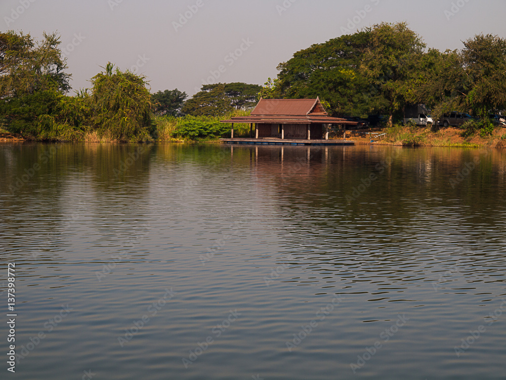 Fototapeta premium Wide river with green forest and sky with clouds.