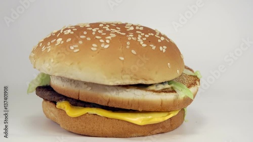 Fast food burger quite unappetizing falls on white background