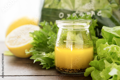 Photo bottle of homemade basic salad dressing made with olive oil lemon juice honey sa