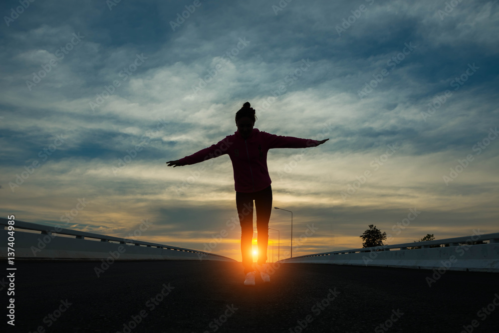 silhouette of woman pointing with finger in sky