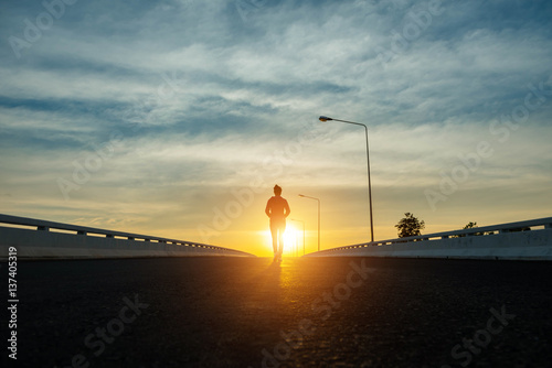 silhouette woman walking on the street at sunset.