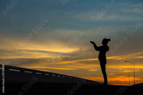 silhouette of woman hands with sunset light © stcom