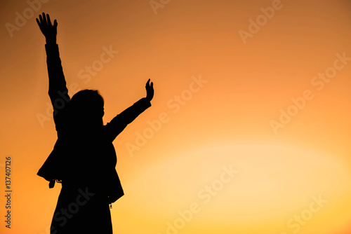 Silhouette of a woman with evening sky.