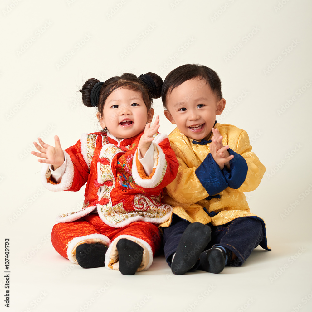 Chinese baby boy and girl in traditional Chinese New Year outfit