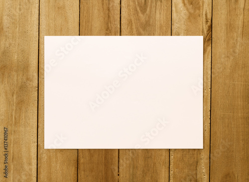 White paper on wood background